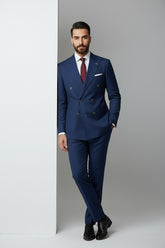 Man wearing navy double-breasted suit with peak lapels, perfect for formal events.